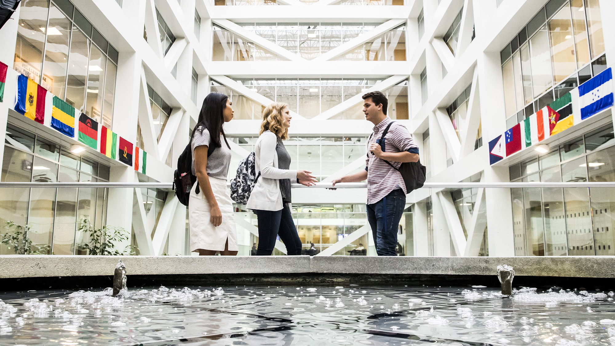 Three business students conversing in BYU's Tanner Building