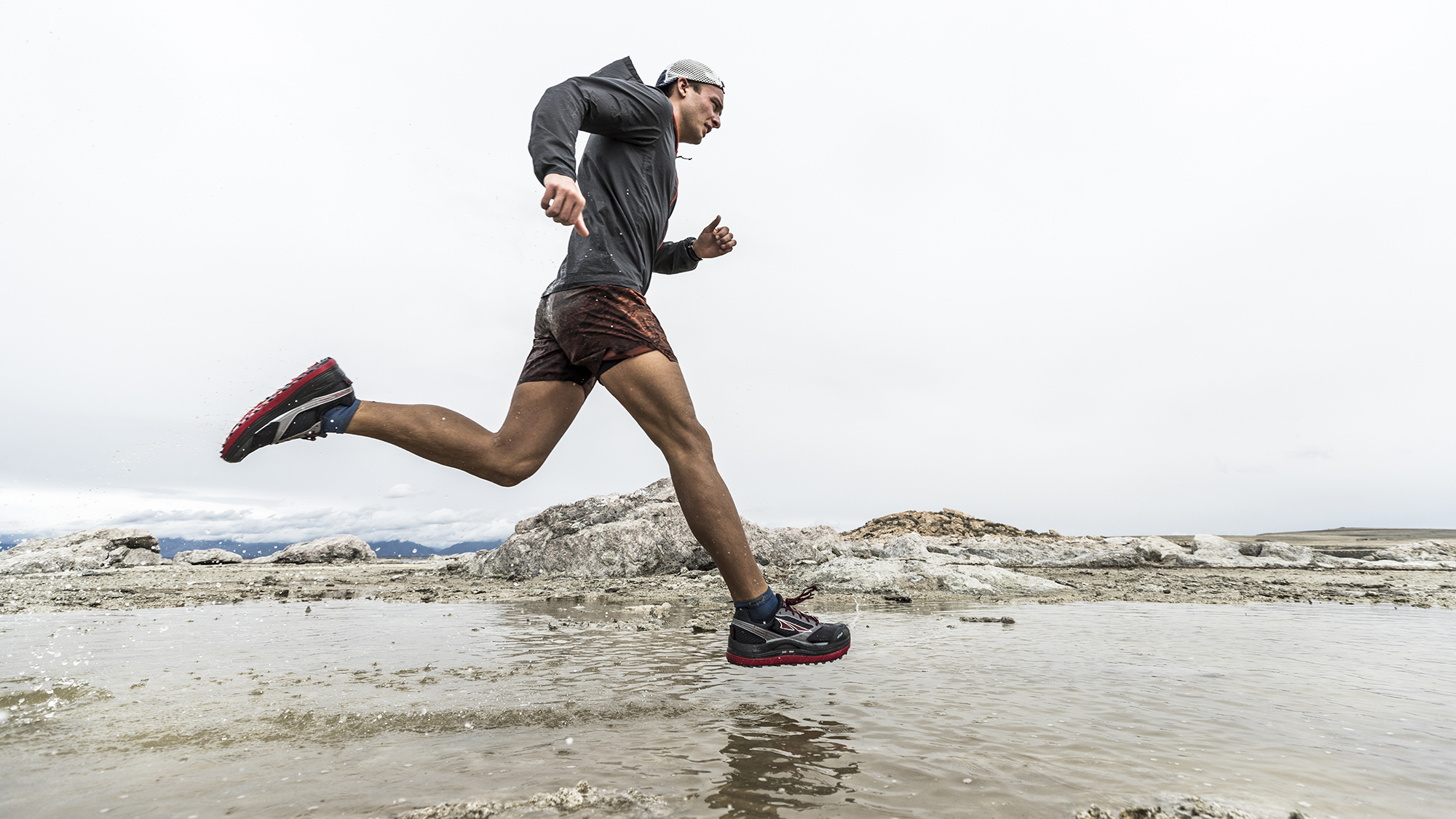 Male runner on a wet beach