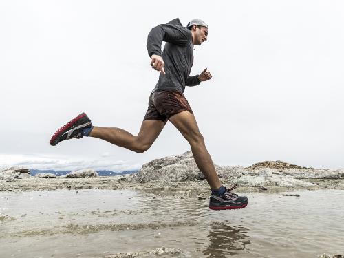 Male runner on a wet beach