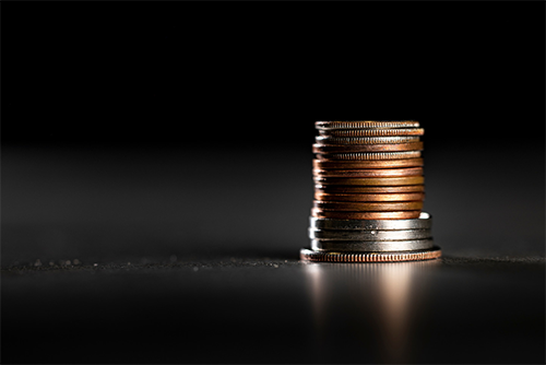 stack of coins on dark background