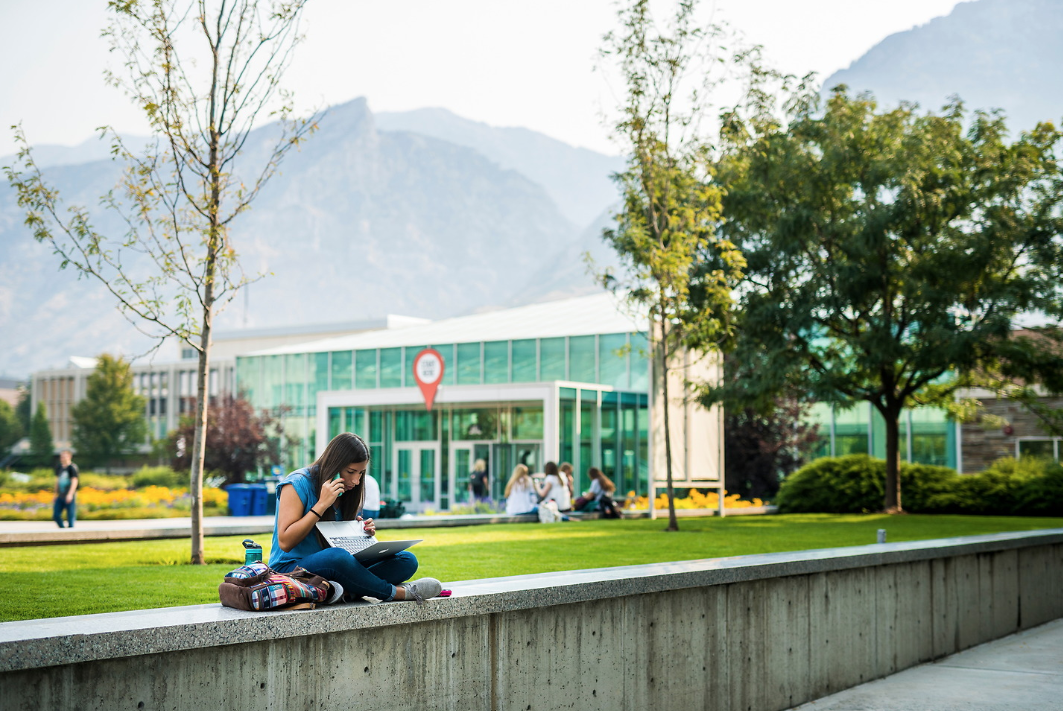 woman studying with laptop outside of Harold B. Lee Library